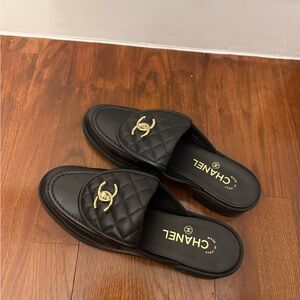CHANEL Black Quilted Leather Slide Mules with Gold Logo